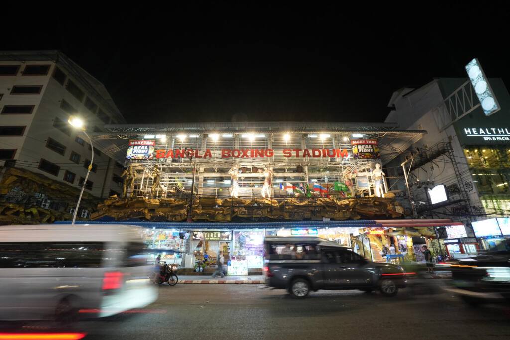 Bangla Boxing Stadium entrance lit up at night with fighter statues above Bangla Road