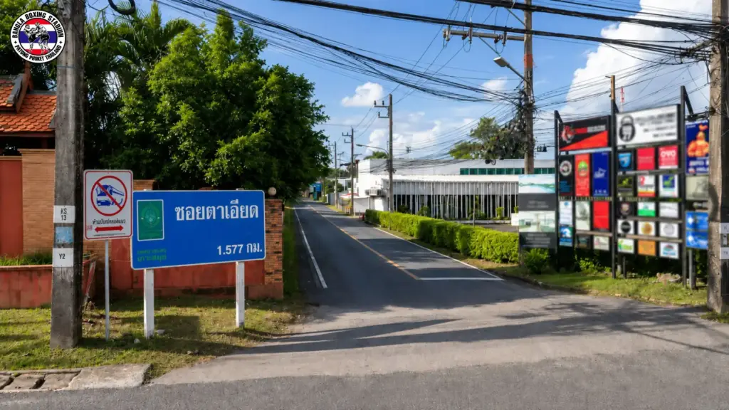 Street view of Soi Ta iad with road signs and gym directory for Muay Thai in Phuket