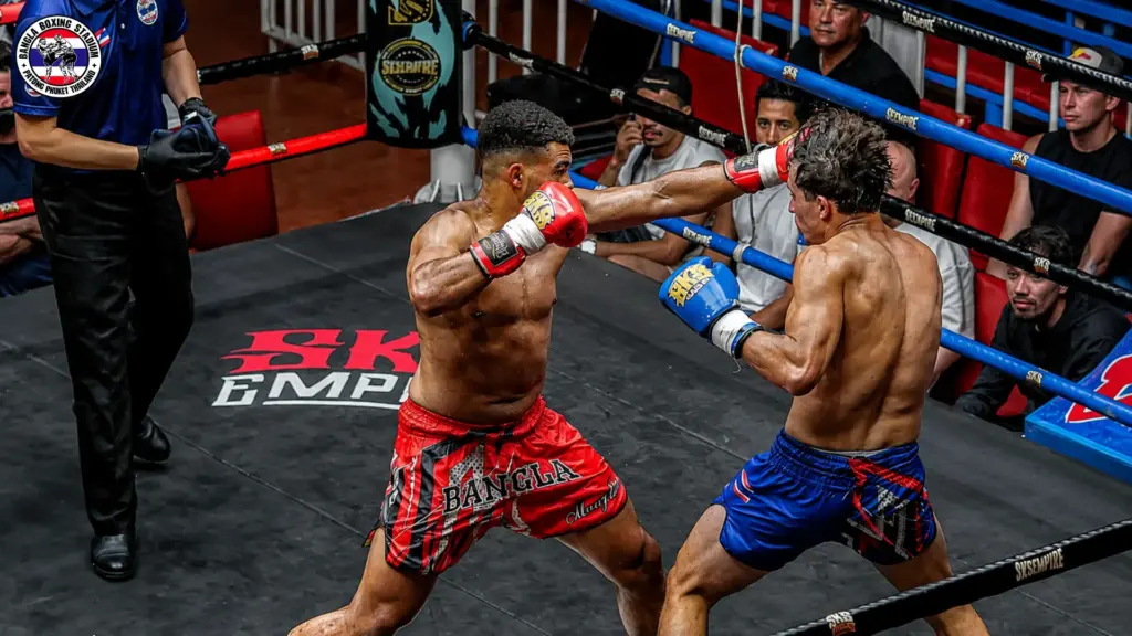 Professional Muay Thai boxers competing in a match at a Phuket boxing stadium