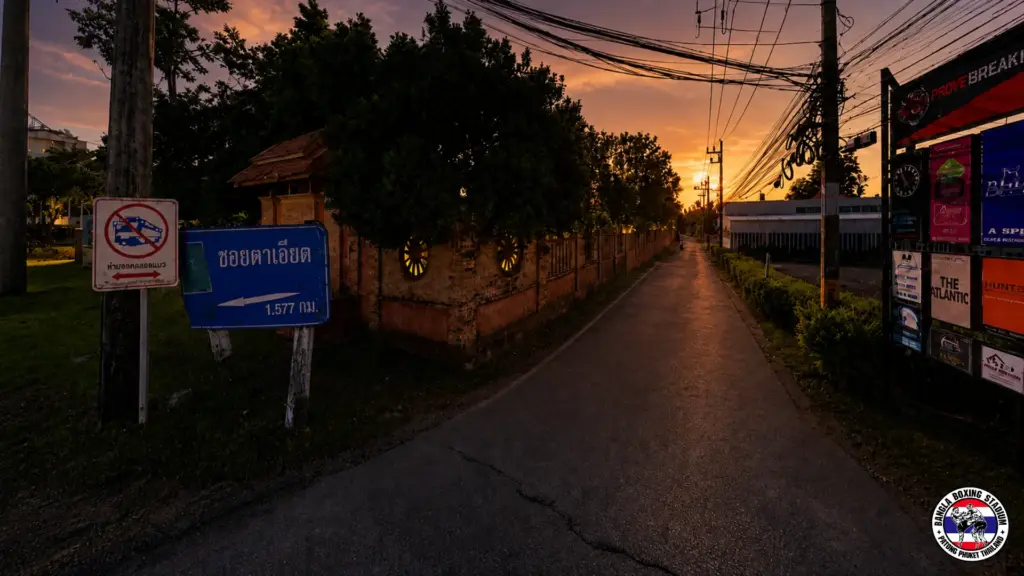 Sunset view of Soi Ta-Iad street in Phuket known for Muay Thai training camps and gyms.