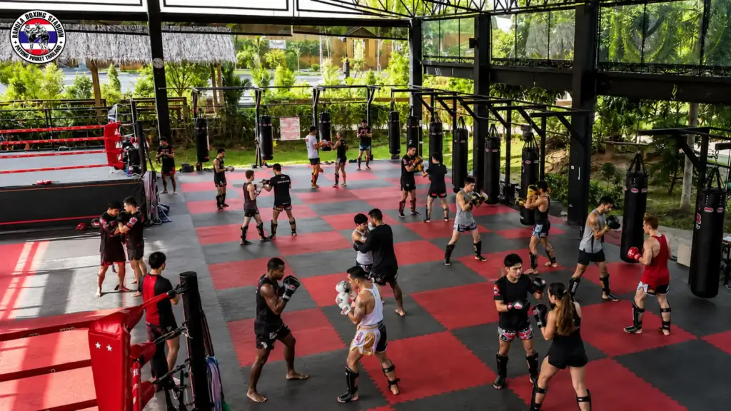 Muay thai athletes practicing techniques at a boxing gym in Phuket
