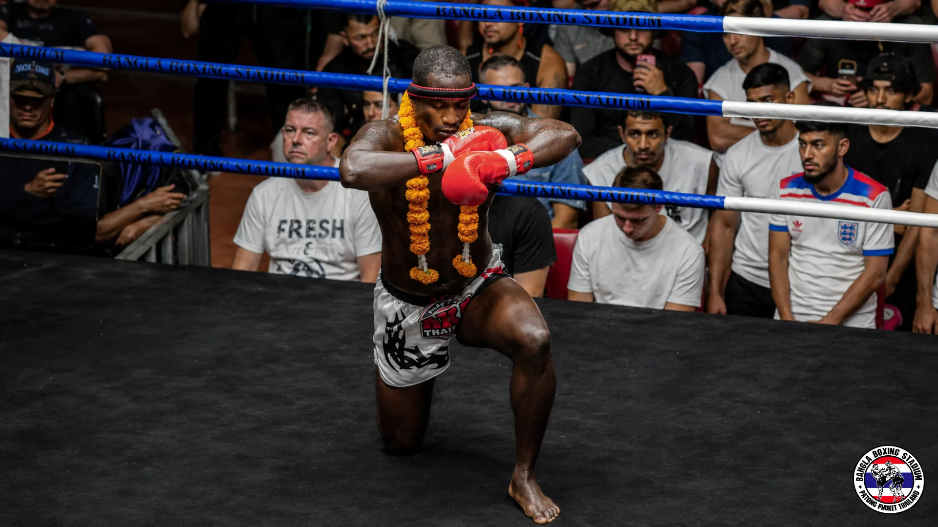 Fighter performing the Wai Kru ritual before a bout at Bangla Boxing Stadium