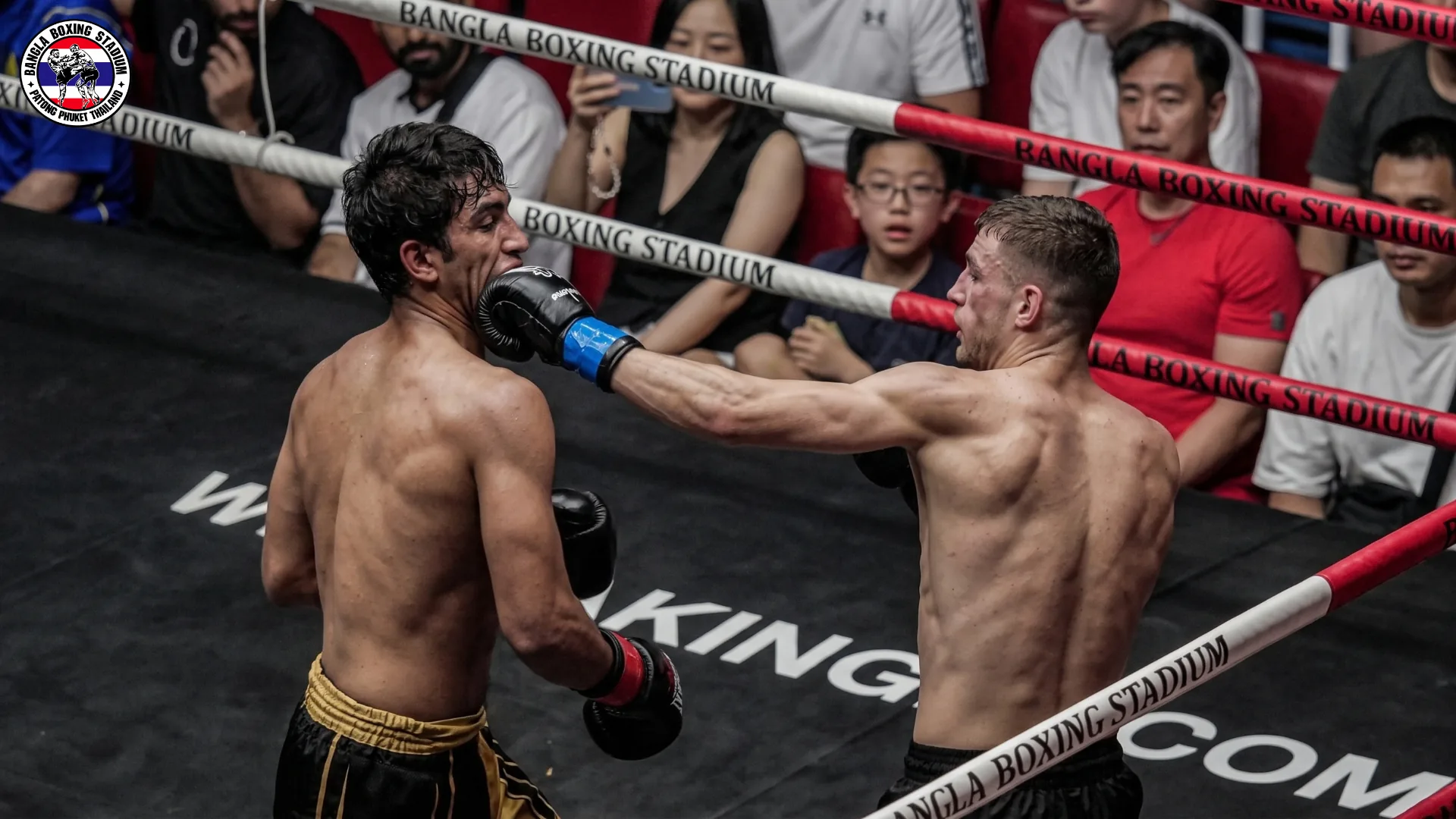 Muay Thai fighter landing a jab on his opponent at Bangla Boxing Stadium in Patong