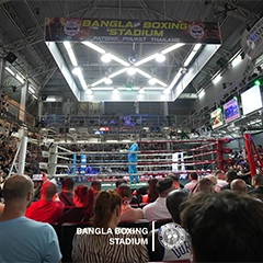 Crowd watching a Muay Thai fight under the Bangla Boxing Stadium banner