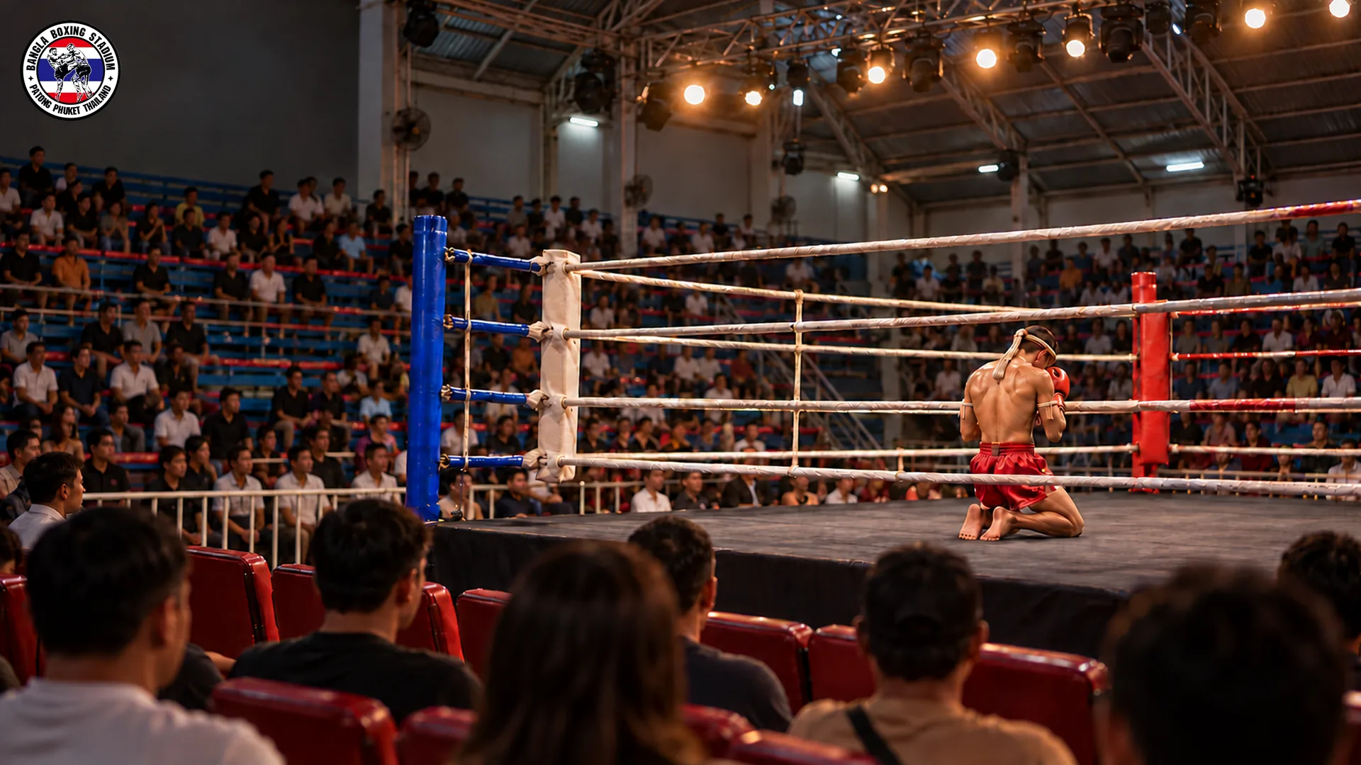 Muay Thai fighter performing the Wai Kru ritual in the ring corner at Bangla Boxing Stadium